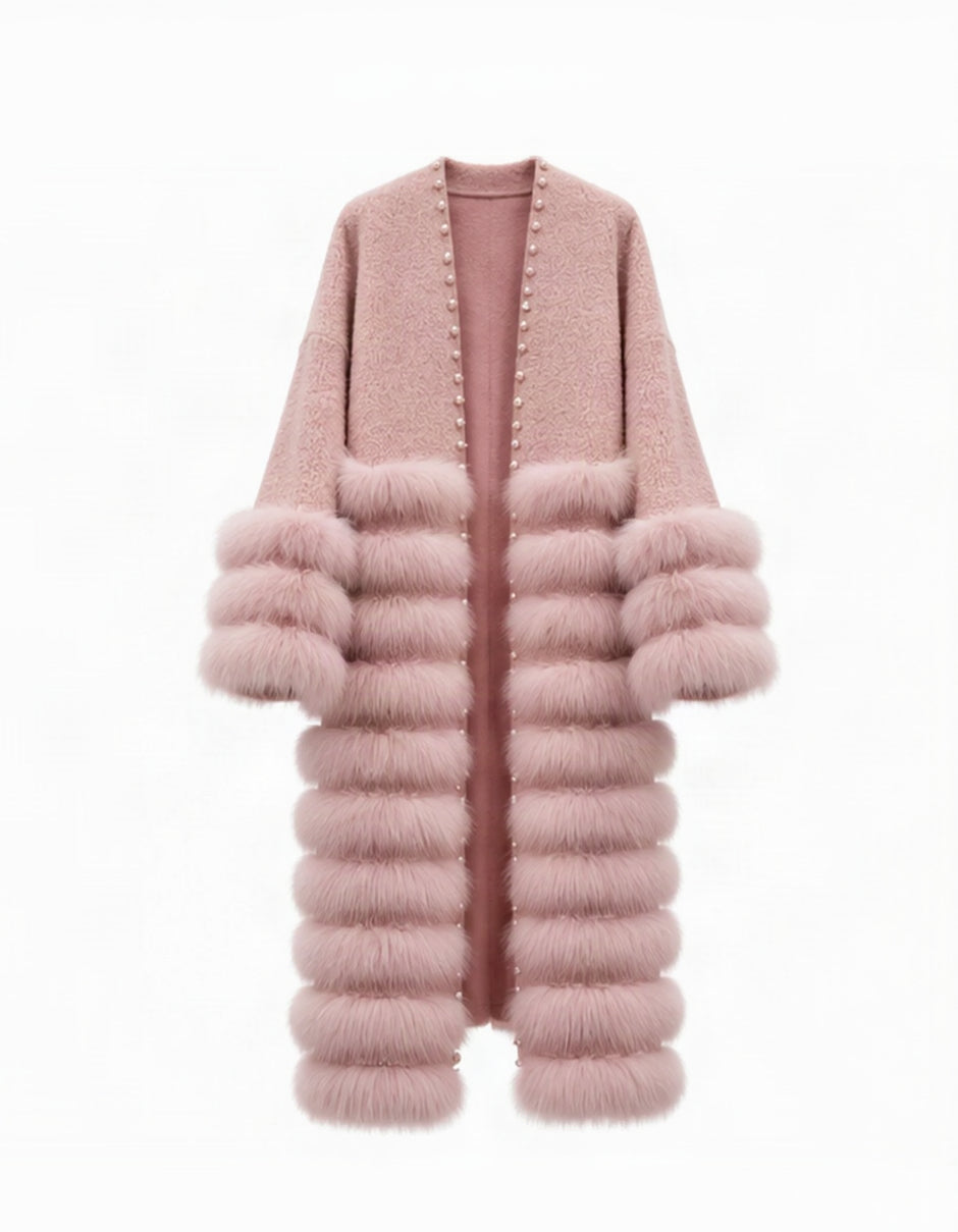 A long open-front cardigan in dusty pink, featuring a smooth knit upper section, a thick faux-fur collar, and stacked faux-fur sleeve cuffs and hem, with small metallic studs along the front opening.