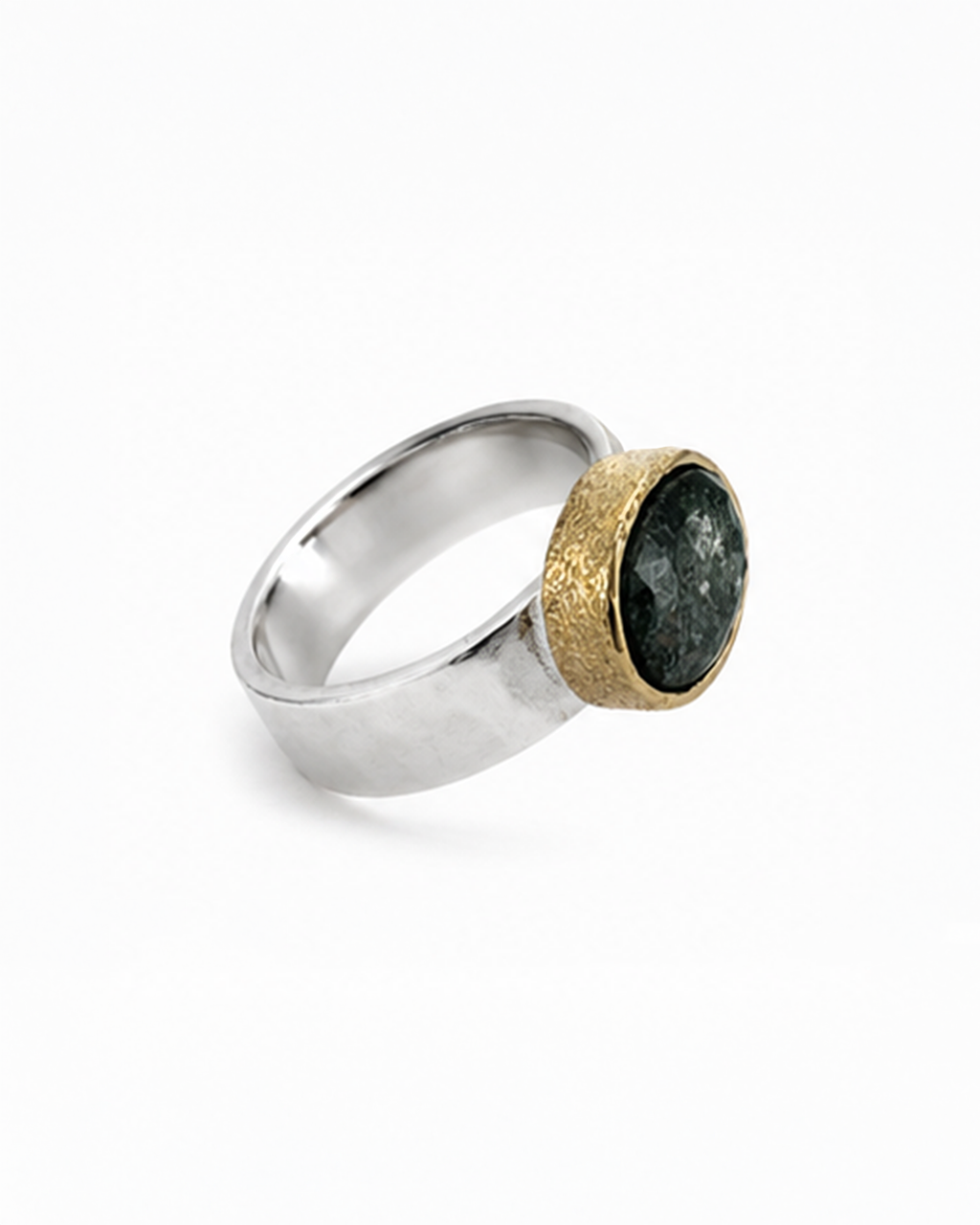 Silver ring with a gold and black stone on a white background