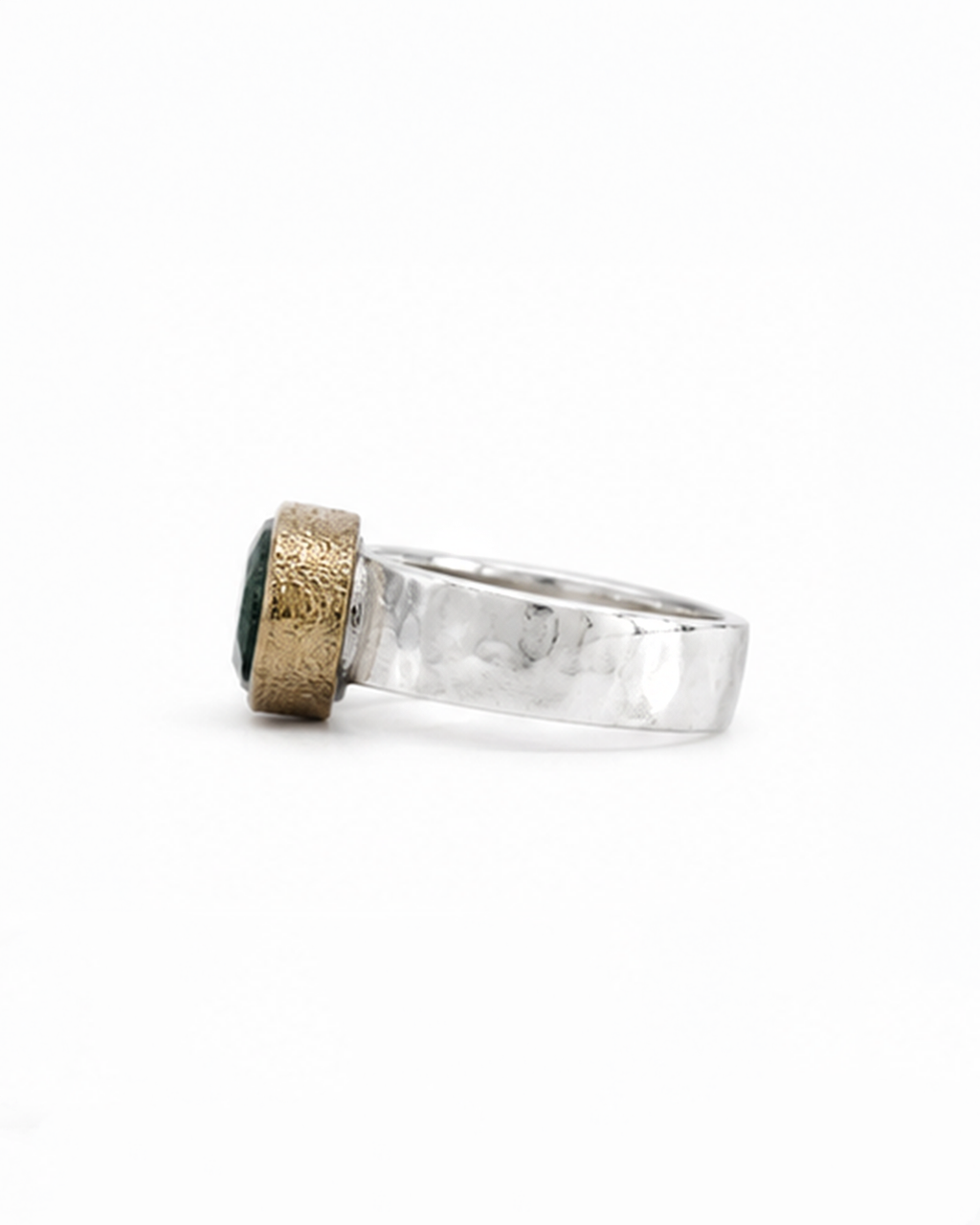 Gold ring with green gemstones and small diamonds on a white background