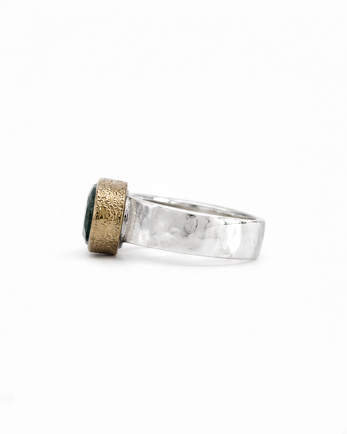Gold ring with green gemstones and small diamonds on a white background