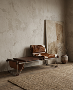Modern lounge chair with cowhide pattern in a minimalistic room.