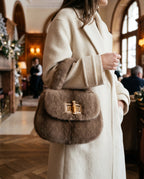 St Moritz Mink Bag carried in a hotel lobby