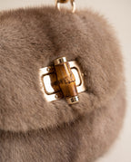 Close up of the gold turn lock on the St Moritz Mink Bag