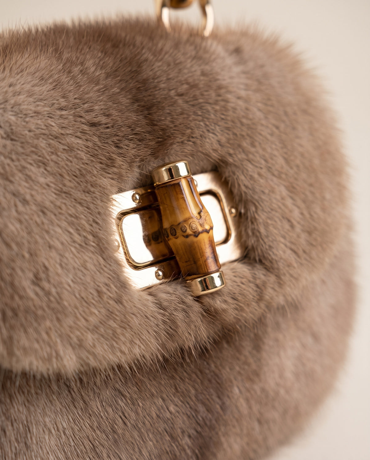 Close up of the gold turn lock on the St Moritz Mink Bag