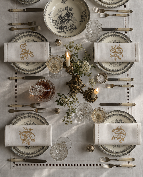 The Belle Époque Napkin at a candlelit dinner table set for four