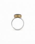 Ring with gold and silver design on a white background
