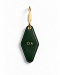 A dark green leather keychain with a gold-tone metal clasp and gold 'EST.2007' text, shown on a clean white background.