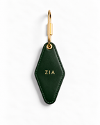 A dark green leather keychain with a gold-tone metal clasp and gold 'EST.2007' text, shown on a clean white background.