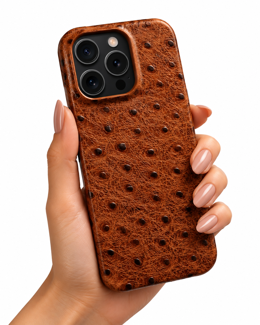 A hand holding a brown ostrich-embossed leather phone case with a black camera cutout, shown against a plain white background.