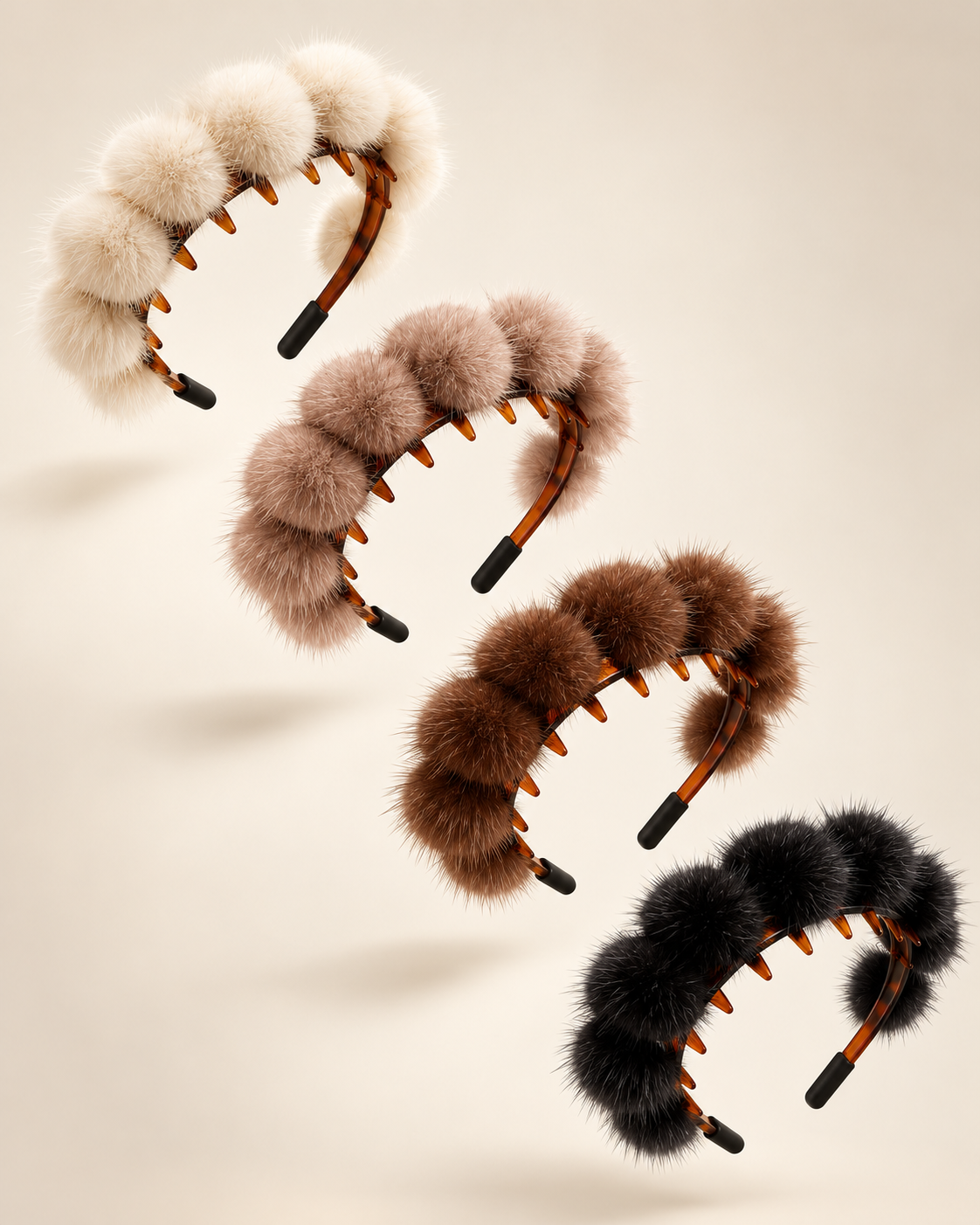 Four fluffy pom-pom headbands in cream, taupe, brown, and black, arranged diagonally on a warm beige background.