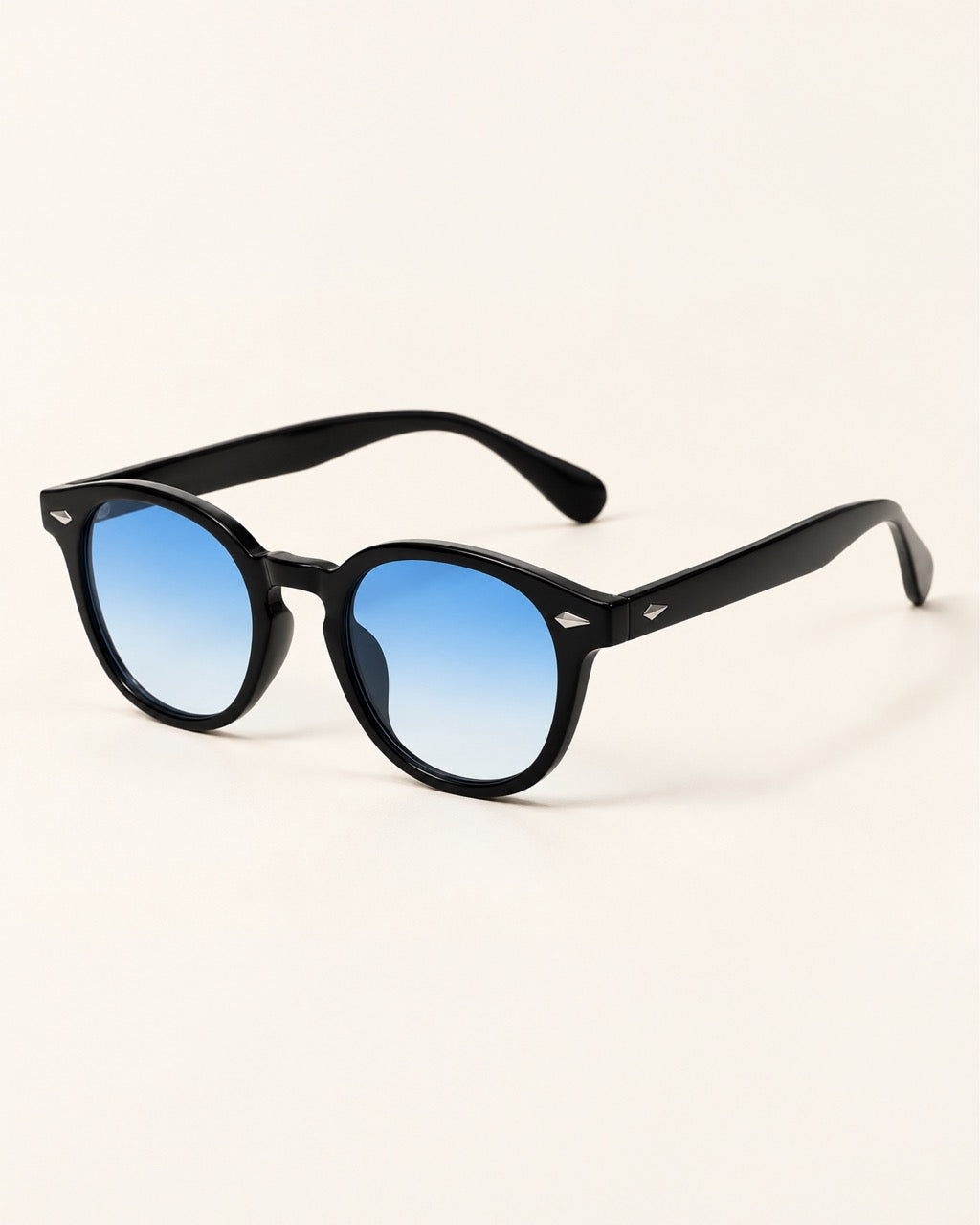 Black round-frame sunglasses with blue gradient lenses, displayed on a clean off-white background.