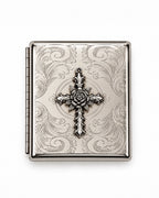 A rectangular silver-toned metal case with an ornate embossed scroll pattern and a central cross motif featuring a rose detail, shown on a plain white background.