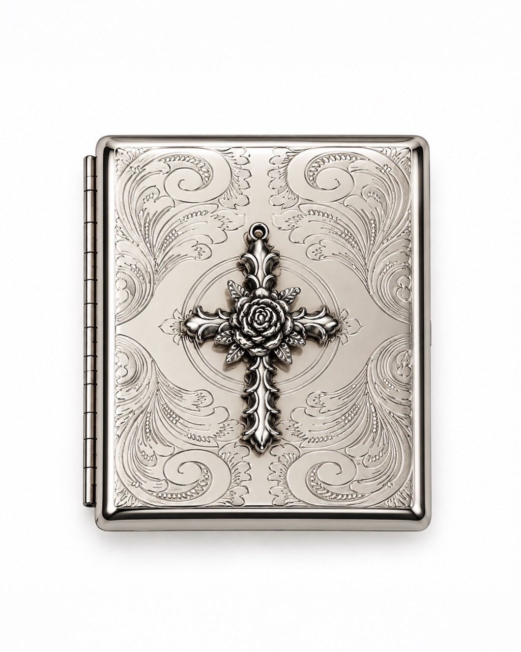 A rectangular silver-toned metal case with an ornate embossed scroll pattern and a central cross motif featuring a rose detail, shown on a plain white background.