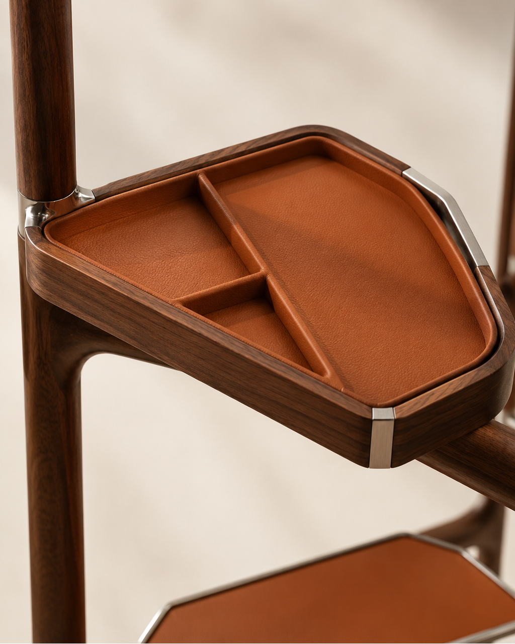 Close-up of a wooden storage tray with a terracotta-colored interior, mounted on a dark wood furniture piece against a soft beige background.