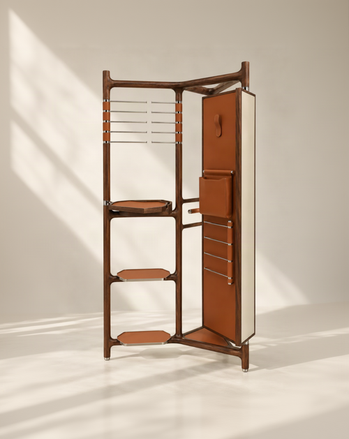 A mid-century modern wooden storage cabinet with a warm brown wood frame, terracotta-brown leather shelves and door panels, and silver metal hardware, set against a warm beige background.