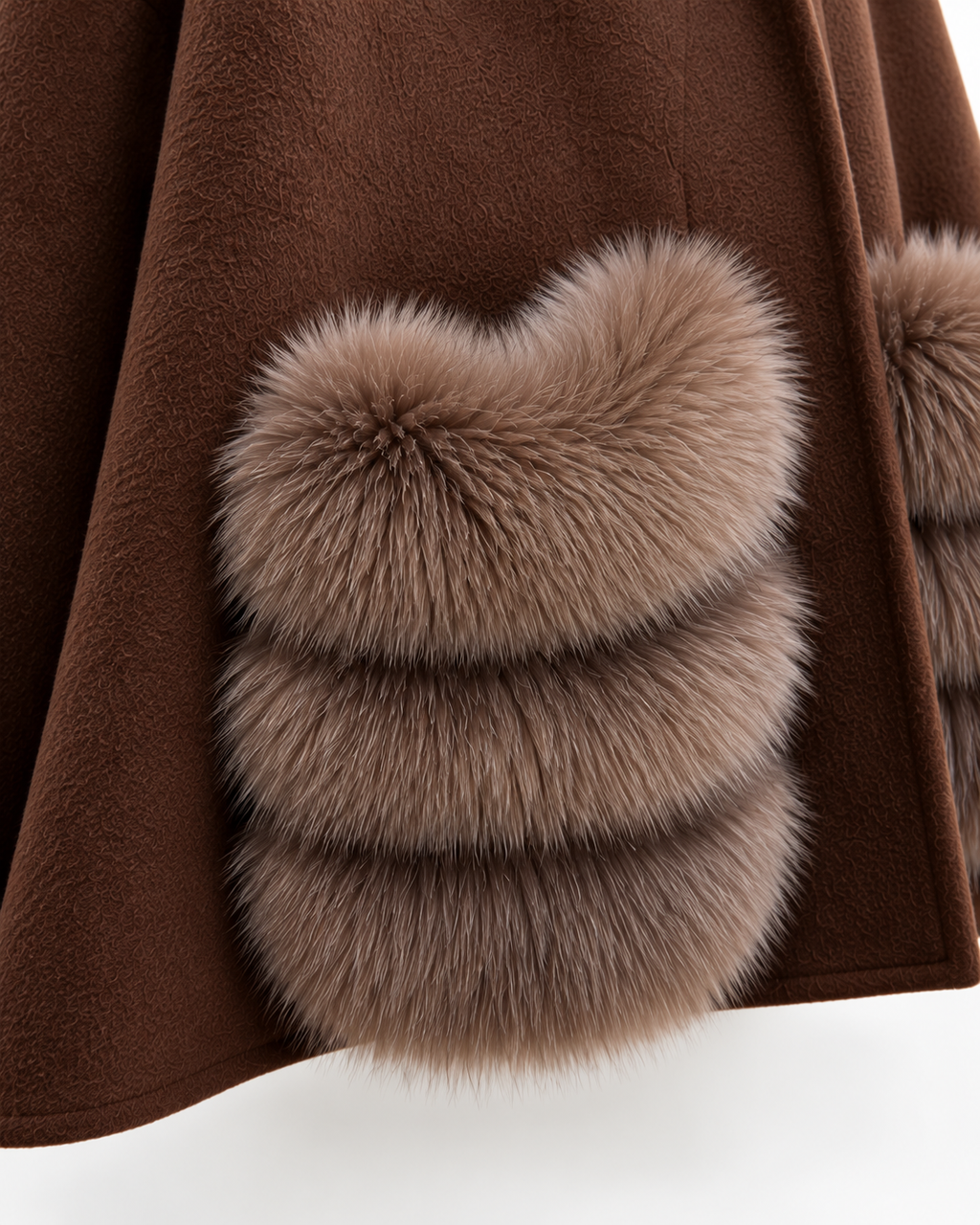 Close-up of a brown coat with a large fluffy taupe-brown fur trim detail on the front.