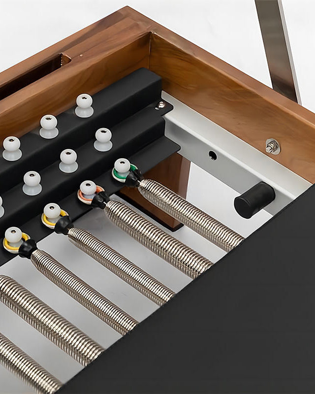 Close-up of a wooden-framed heating or ventilation unit showing black metal baffles, white plastic caps, and multiple corrugated metal ducts connected with colored connectors.