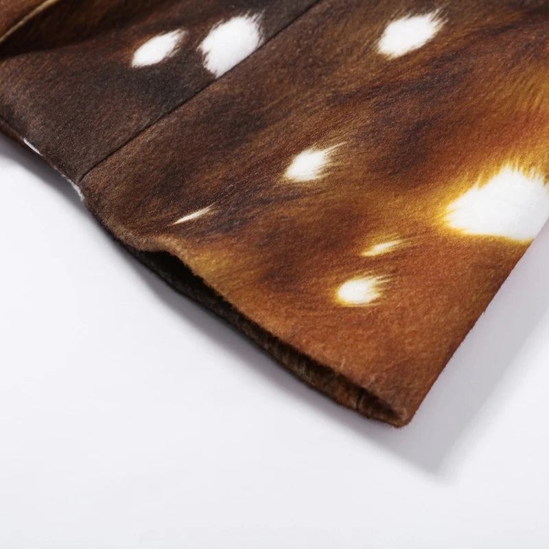 A close-up of a brown animal-print fabric with white spots, folded over on a white background.