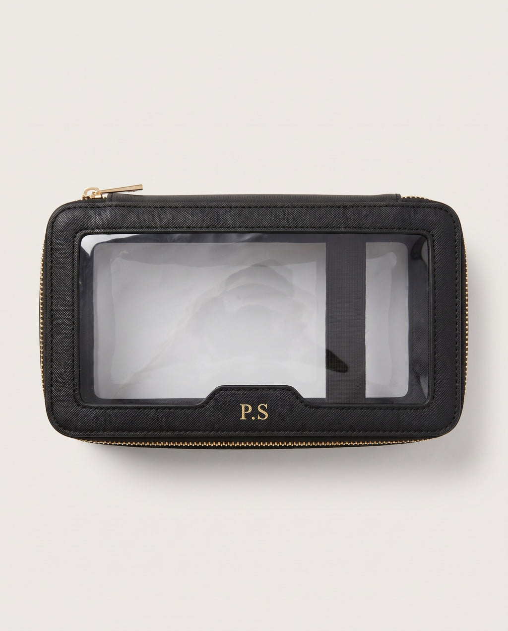 A black textured leather zip-around pouch with a clear plastic ID window and gold-tone hardware, featuring a gold 'P.S' monogram on the front, set against a light off-white background.