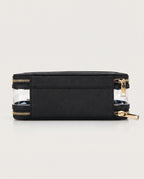 A black rectangular zippered pouch with clear plastic side panels and gold-tone zippers, shown on a light gray studio background.
