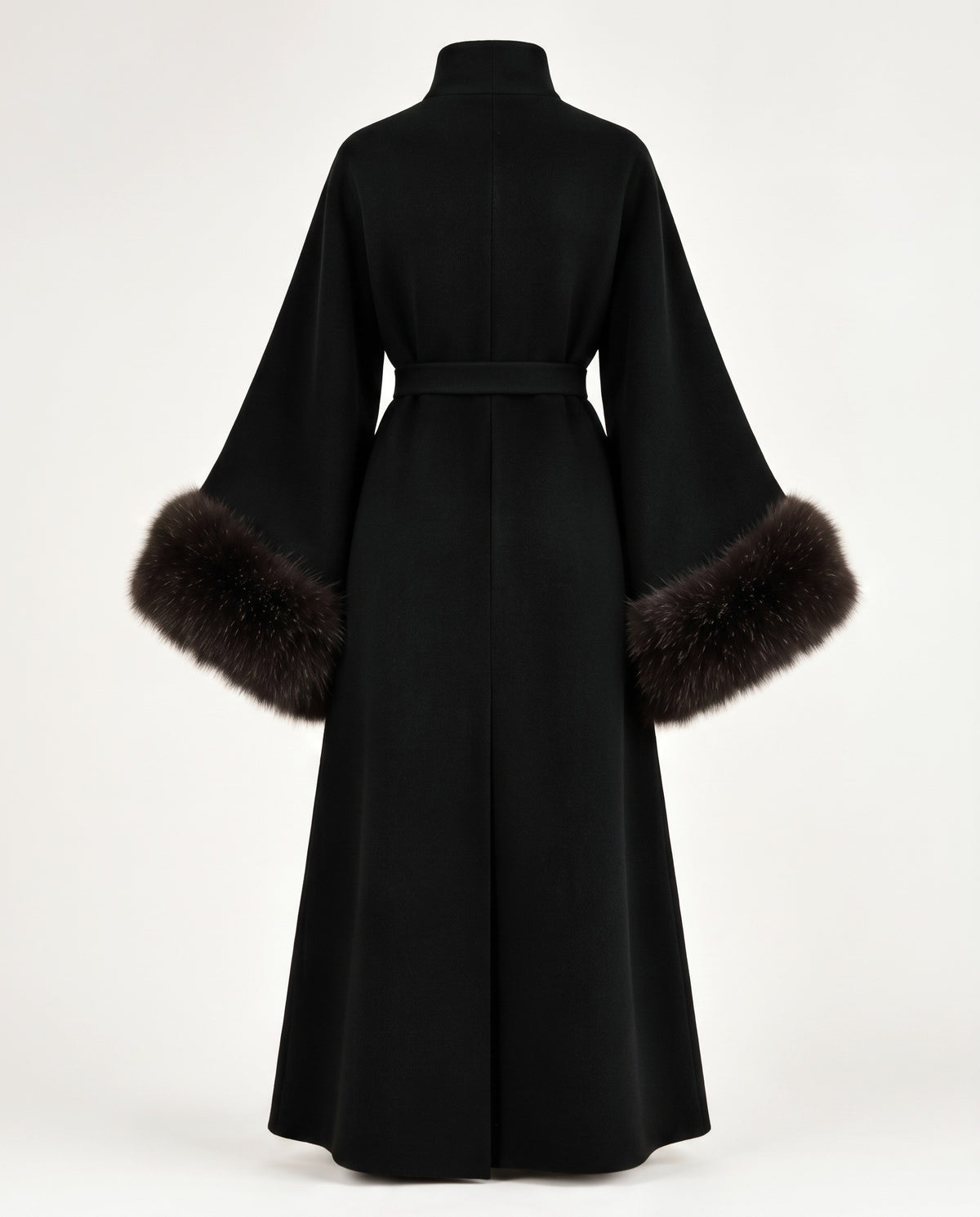 A black long-sleeved wrap coat with a high collar and a matching waist belt, featuring dark brown fur trim at the wide sleeves, shown from the back on a white studio background.