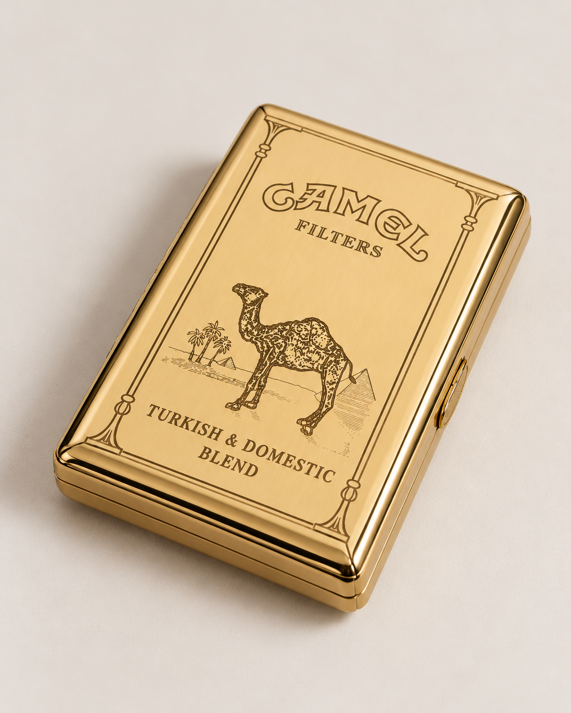 A gold Camel Filters tin box on a light beige background, featuring the classic camel logo and 'Turkish & Domestic Blend' text.