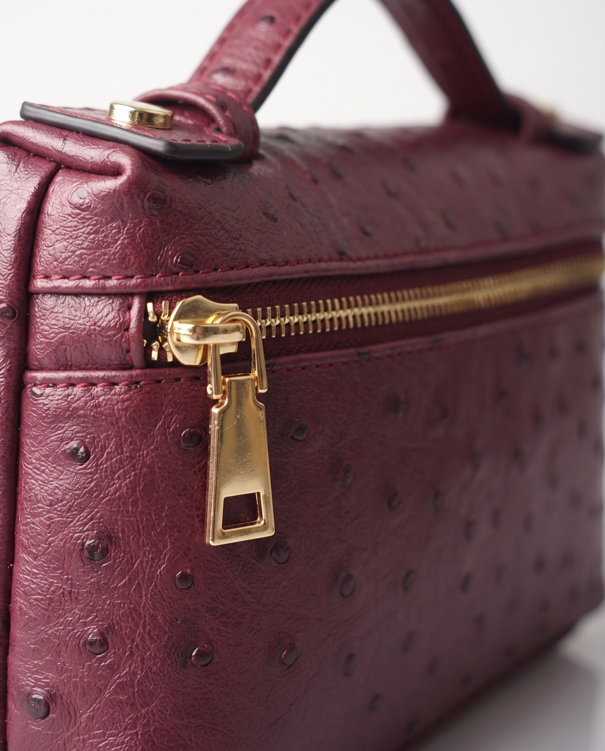 Close up of the ostrich texture and gold zip