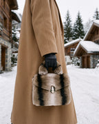 Aspen Fur Clutch carried with a camel coat