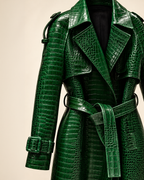Close-up of The Riviera Leather Trench in green croc embossed leather, showing the collar, epaulettes, cuff straps and tie belt
