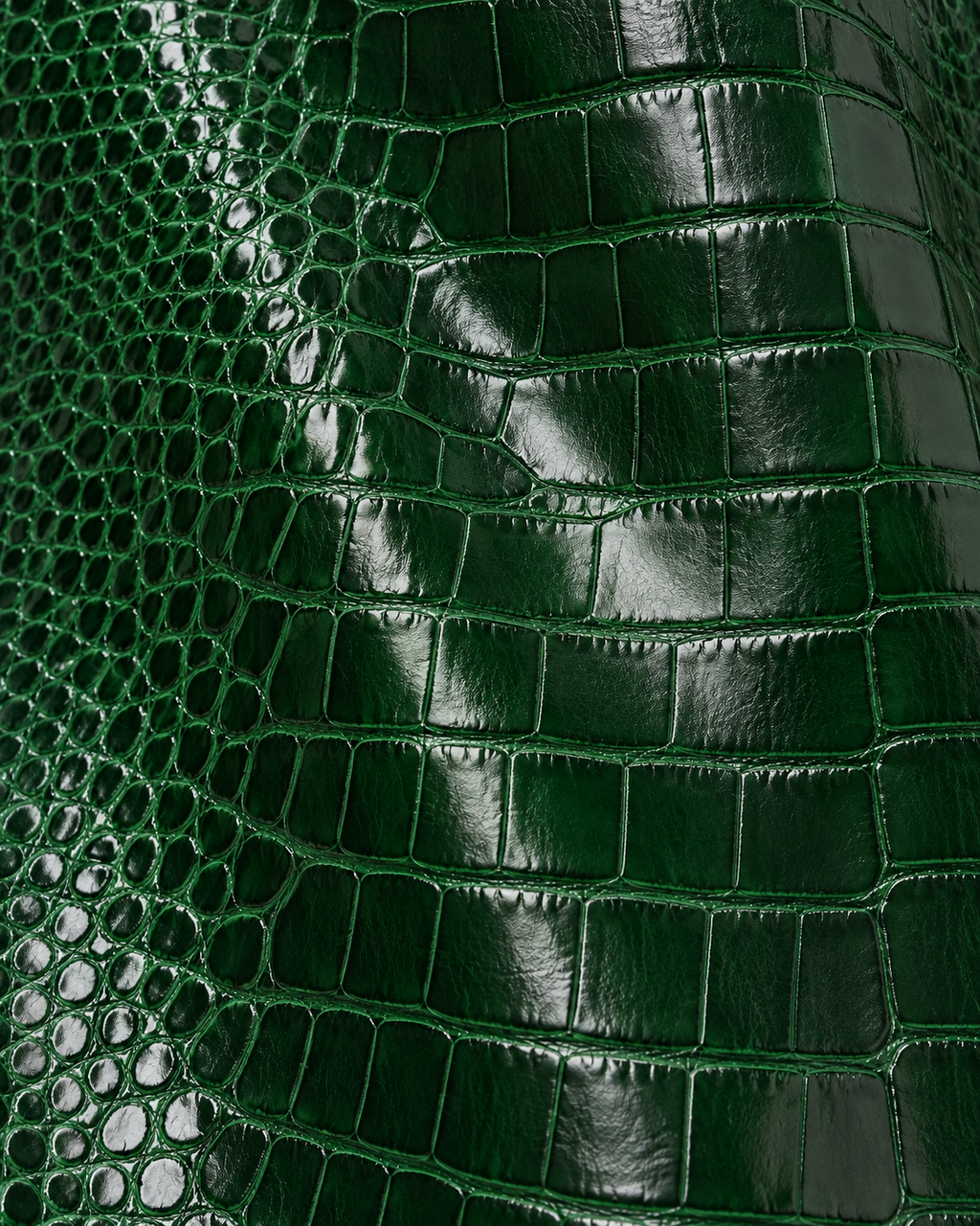 Close-up of the glossy green croc embossed leather on The Riviera Leather Trench
