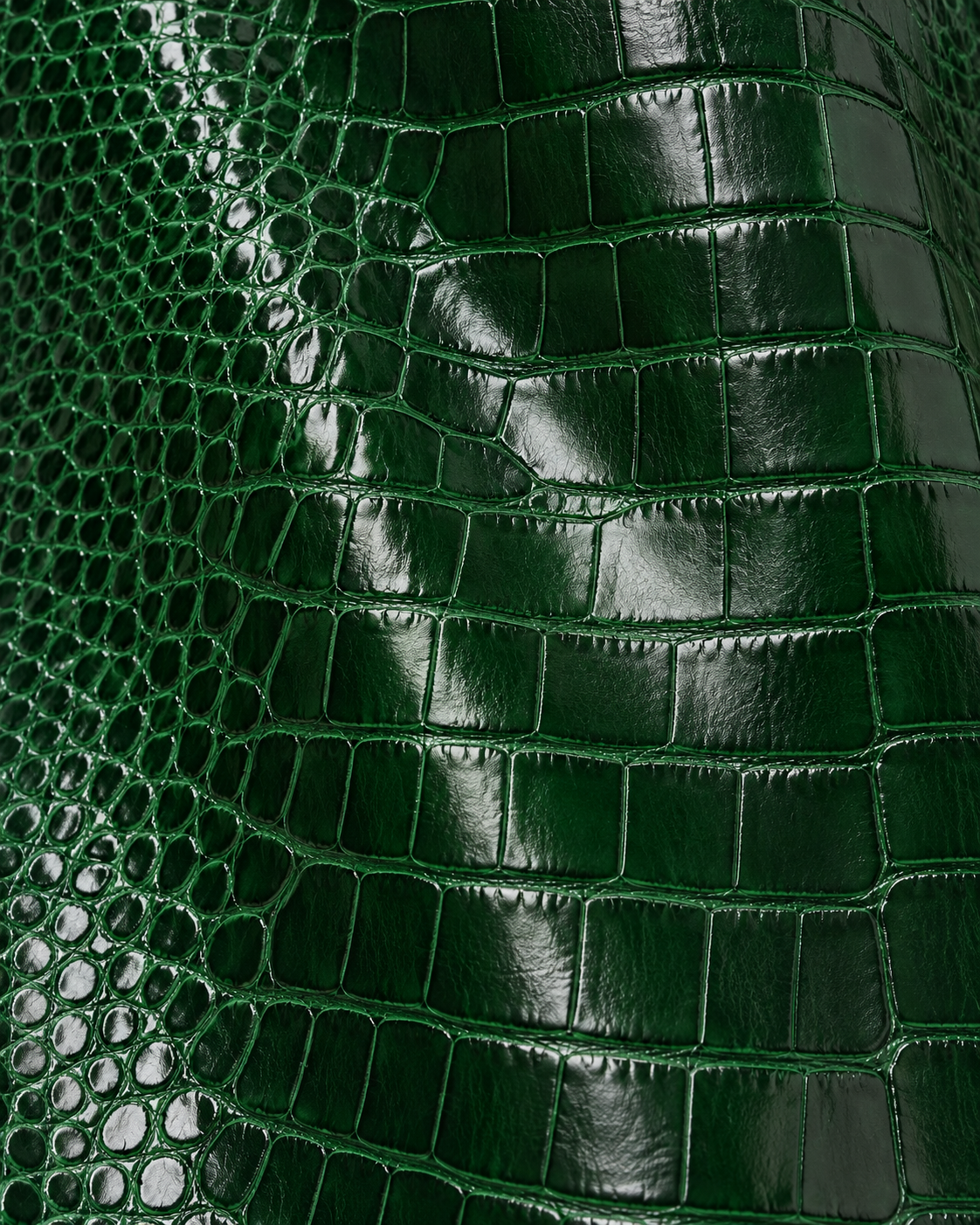 Close-up of the glossy green croc embossed leather on The Riviera Leather Trench