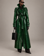 Model wearing The Riviera Leather Trench in green croc embossed leather, belted, with a black handbag