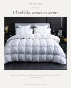 The Cairngorm Down Duvet in white on a bed