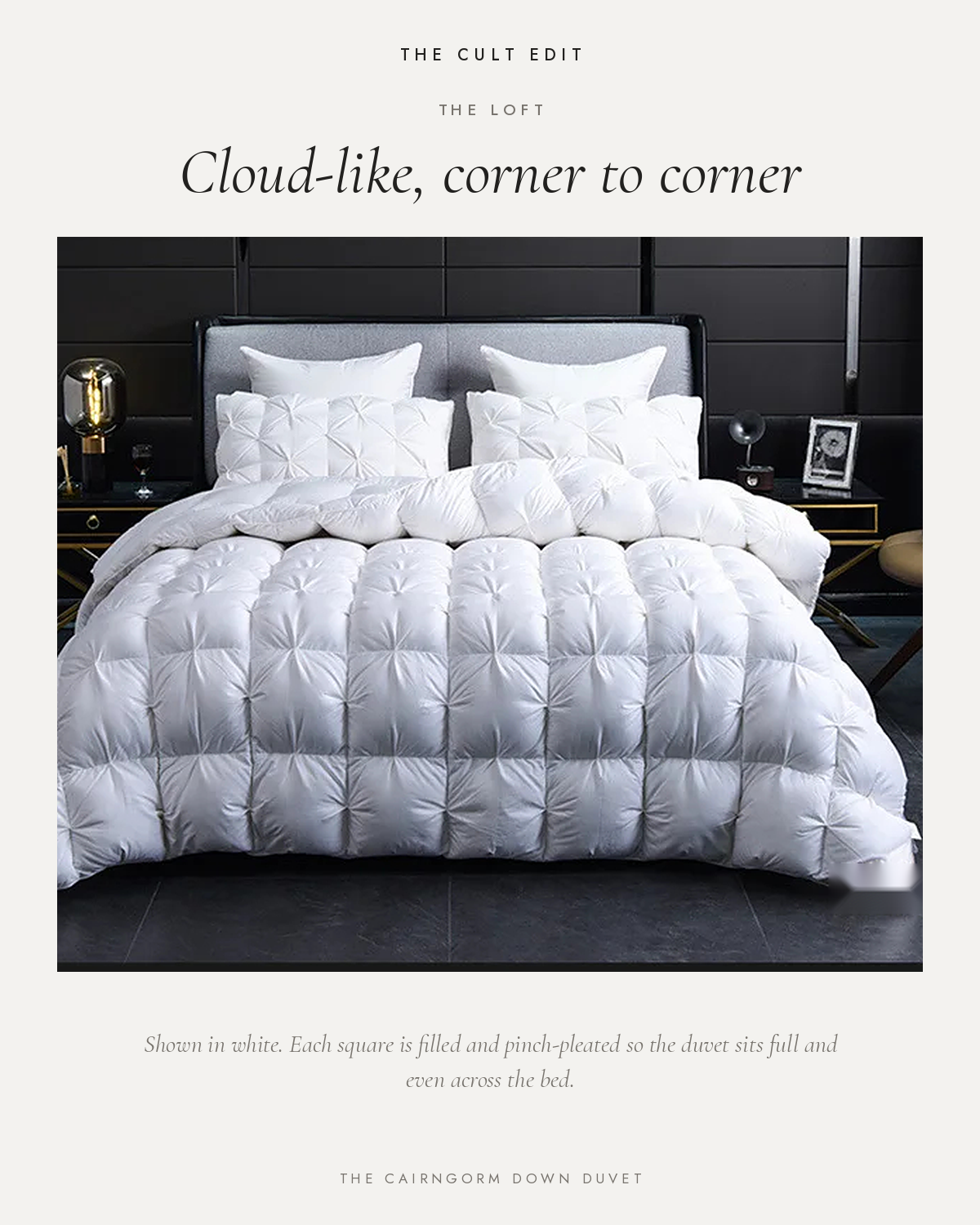 The Cairngorm Down Duvet in white on a bed