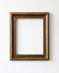 An empty rectangular picture frame with an ornate rope-like inner border and a distressed bronze-brown finish, mounted on a plain white wall.
