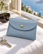 The Mayfair Card Purse in grey blue by a sunny window