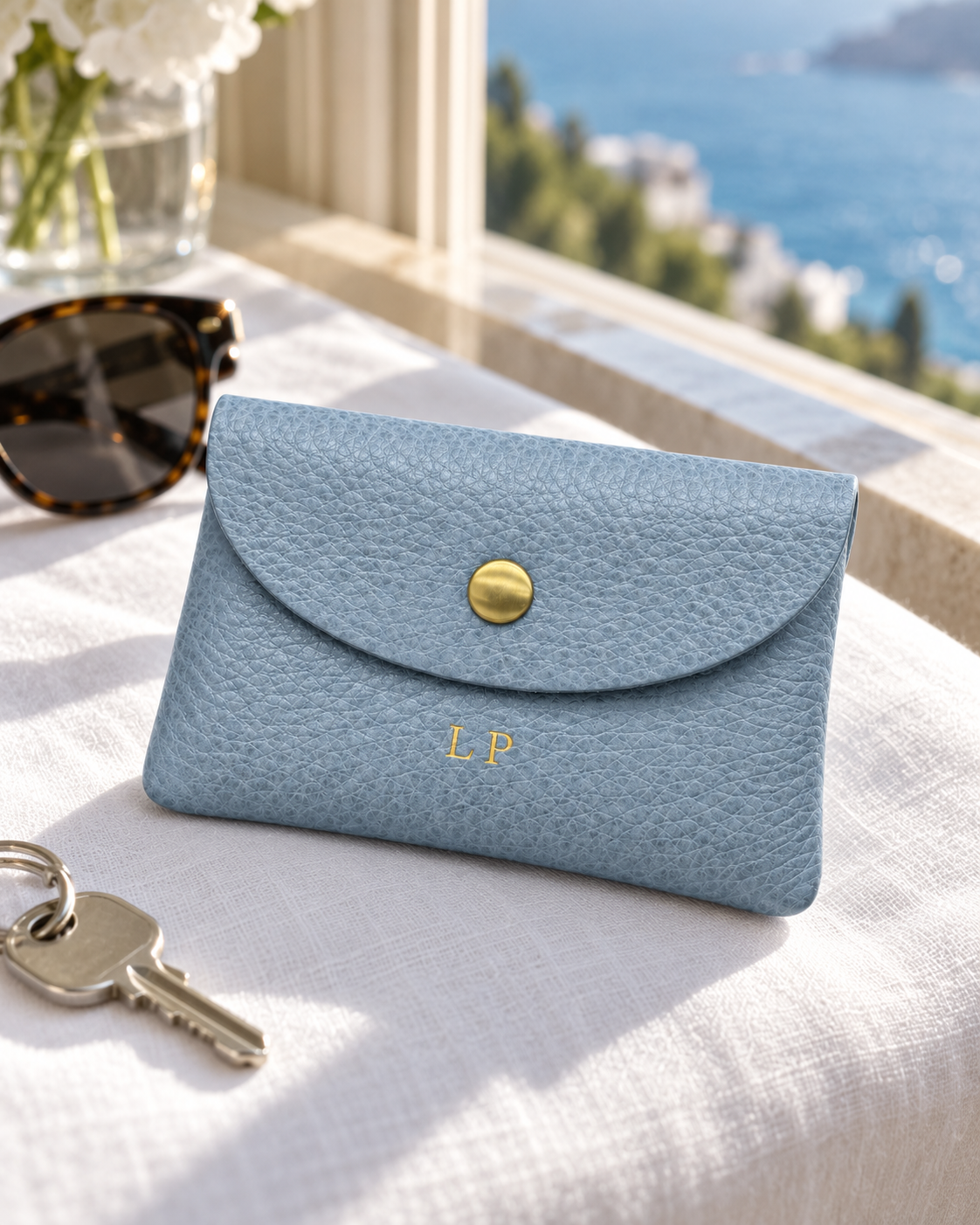 The Mayfair Card Purse in grey blue by a sunny window