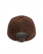 A brown suede baseball cap shown from the back, featuring a curved back strap with a metal snap closure, set against a plain white background.
