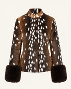 A long-sleeve faux fur jacket with a brown and white spotted deer-print pattern, featuring a mock neck and dark brown faux fur cuffs, shown against a plain off-white background.