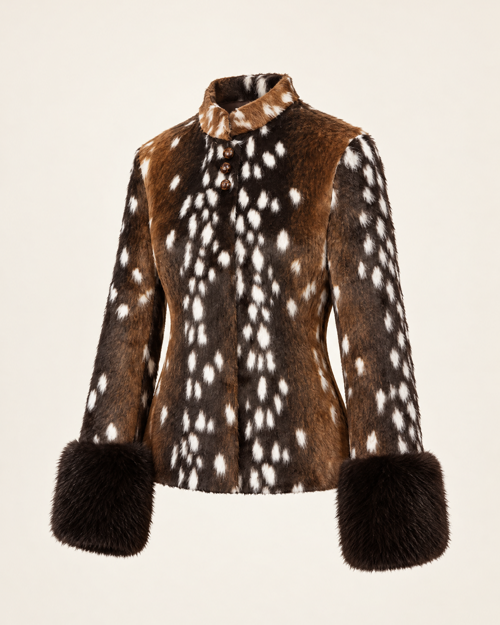 A cropped faux-fur jacket with a brown and white spotted pattern, solid brown yoke panels, and dark brown fur-trimmed cuffs and collar, shown on a plain light beige background.