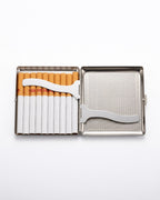 A stainless steel cigarette case shown open on a white background, containing several cigarettes in a left compartment and a silver metal cigarette cutter resting across the divider.