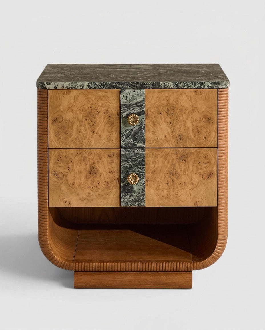 A mid-century modern wooden nightstand featuring burl wood drawer fronts, a dark green marble top and center panel, and gold-toned shell-shaped drawer pulls, set against a light gray background.