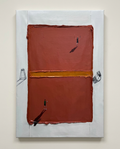 An abstract canvas painting featuring a large terracotta red rectangular form divided by a horizontal gold band, with small black figures and gray architectural sketches on a white border, shown hanging on a light beige wall.