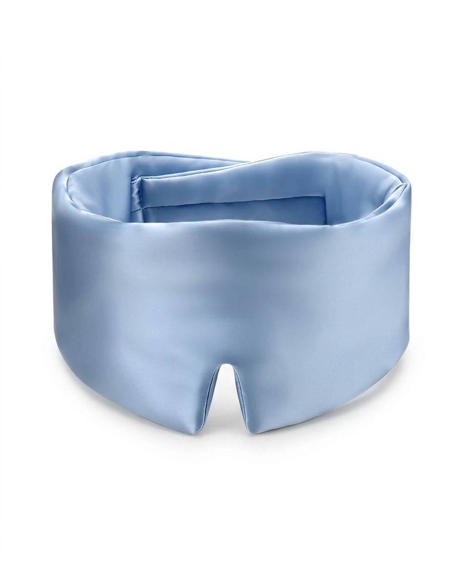 A light blue satin sleep mask with a smooth, lustrous finish, photographed on a clean white background.