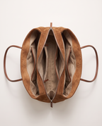 The Marais Tote in Brown from above, unzipped to show the cotton lining and inside pockets