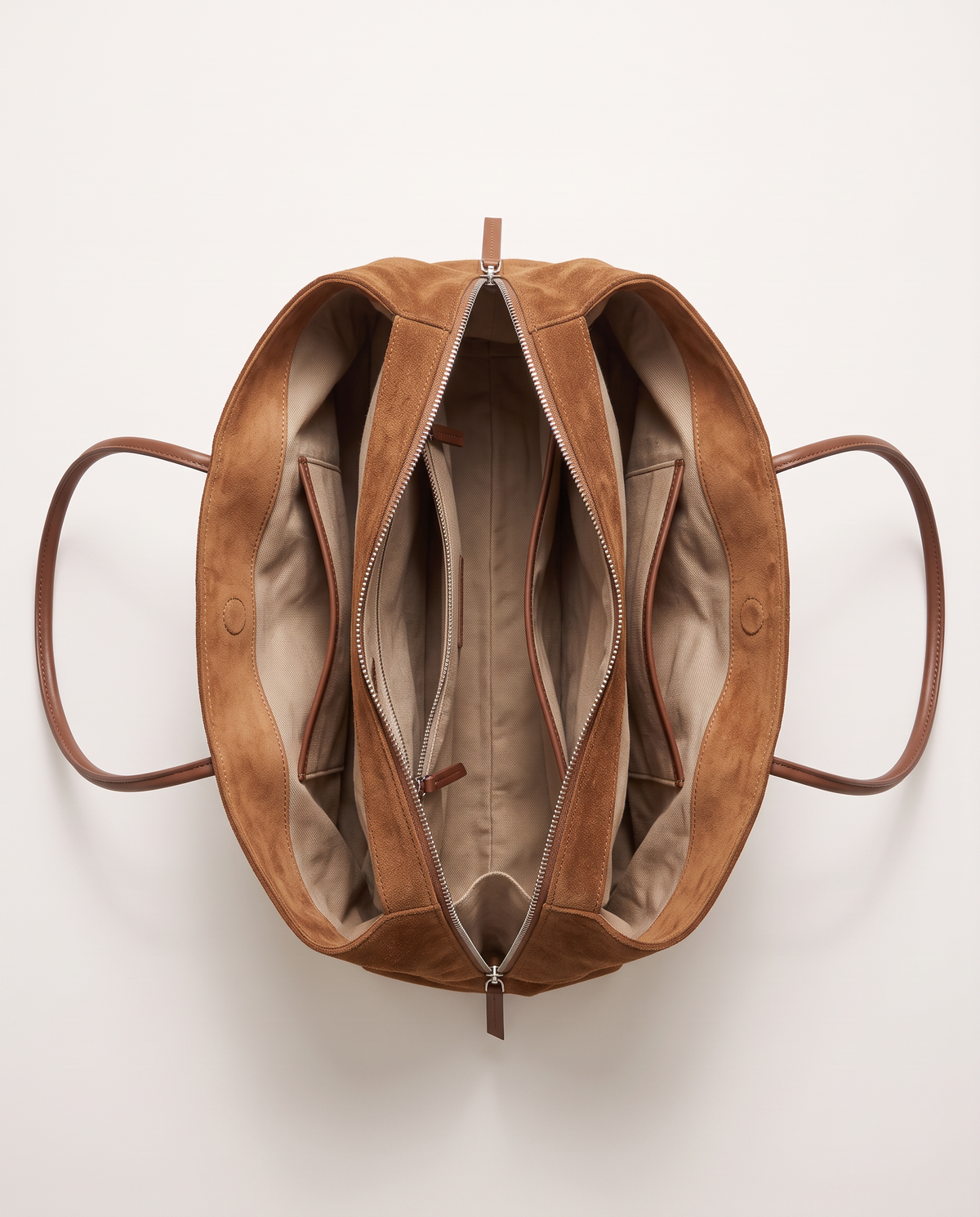 The Marais Tote in Brown from above, unzipped to show the cotton lining and inside pockets