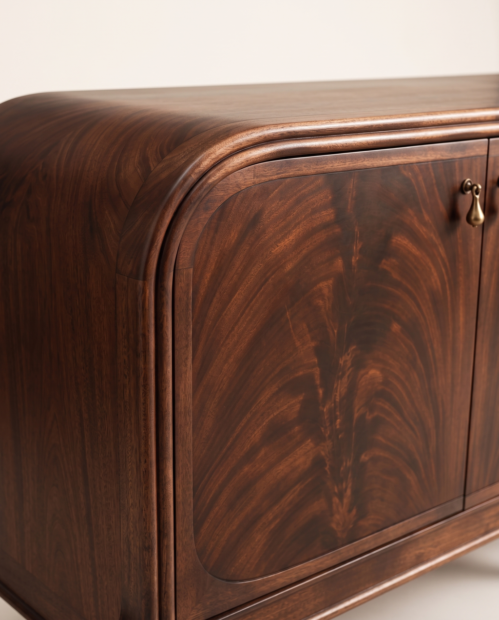 Detail of the rounded end, moulded top, flame mahogany veneer and brass pull