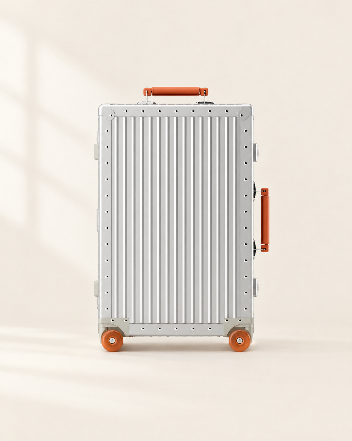 The Meridian Suitcase in silver with orange