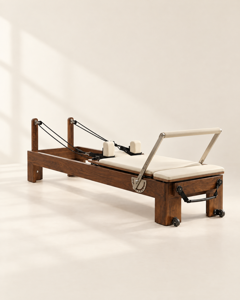 The Pavilion Reformer in walnut with cream upholstery