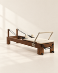 The Pavilion Reformer in walnut with cream upholstery